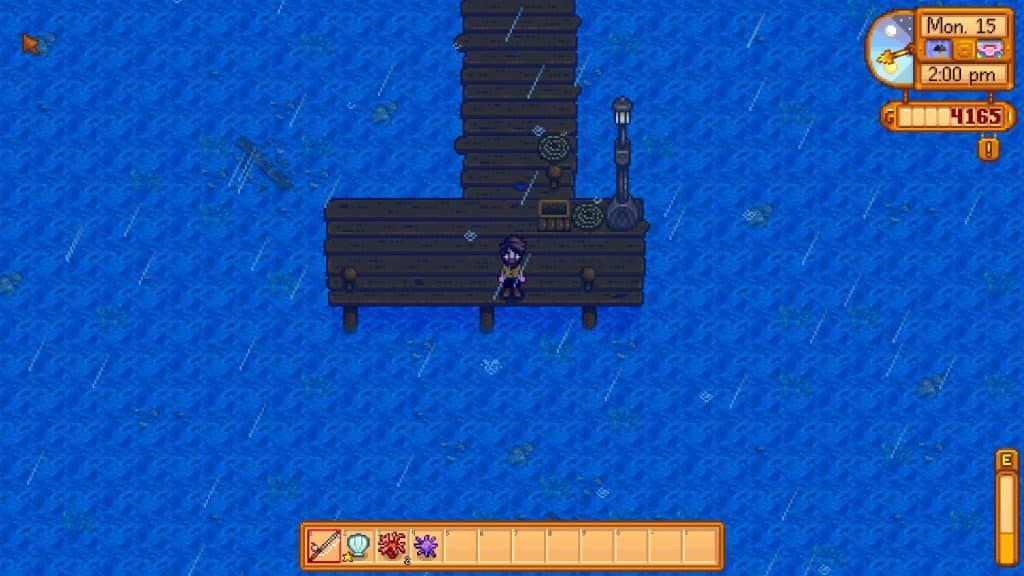 Image shows the fishing spot at the end of the eastern beach pier accessible after repairing the bridge in Stardew Valley.